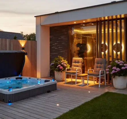 Stijlvol huis met sfeervol verlichte ingebouwde jacuzzi bij schemering