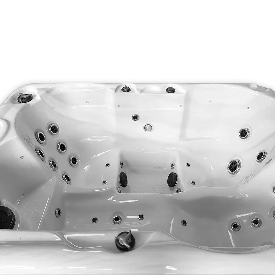 Binnenaanzicht van een witte spa met meerdere zitplaatsen, ergonomische vormen en diverse massagejets op verschillende hoogtes.